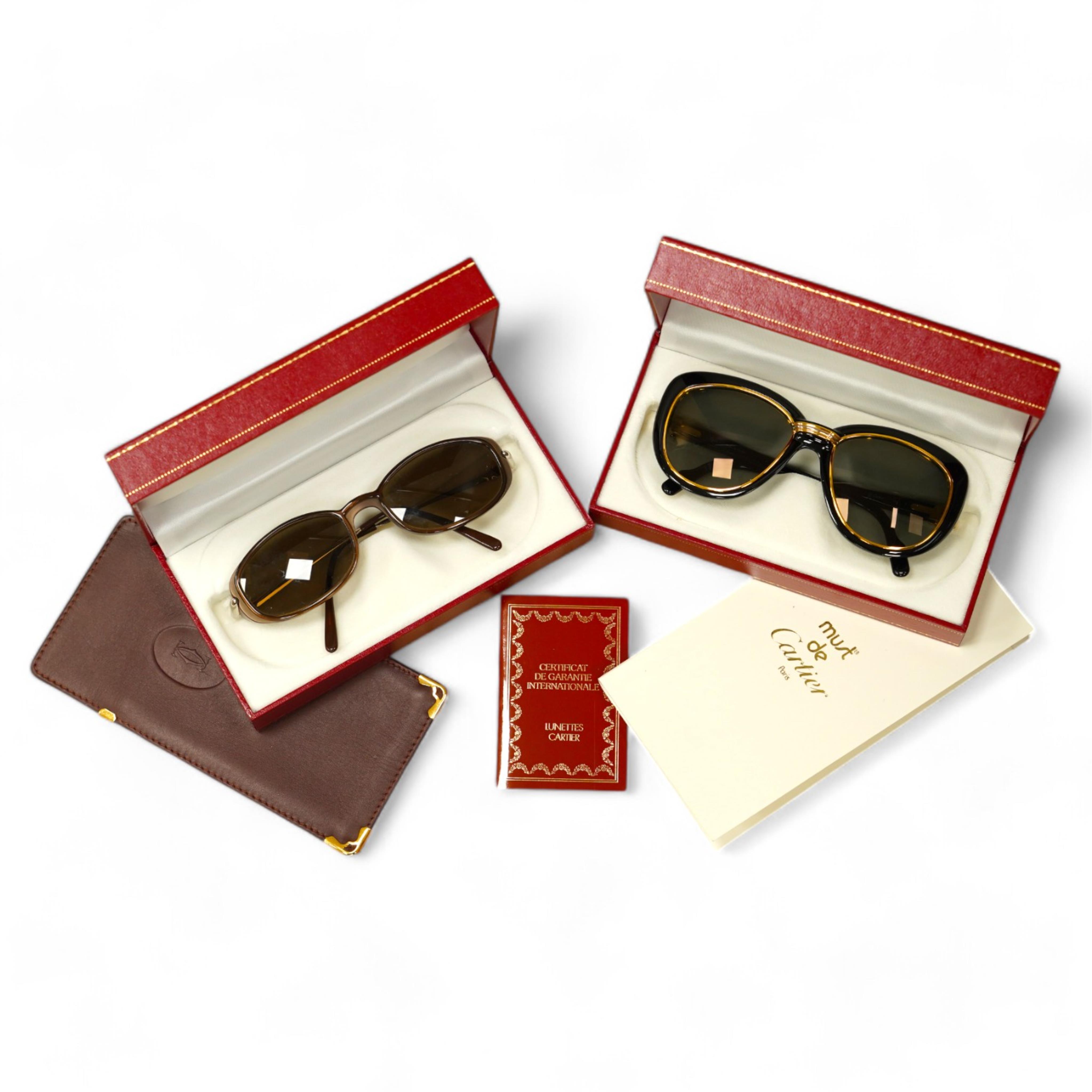 Two pairs of Must de Cartier sunglasses